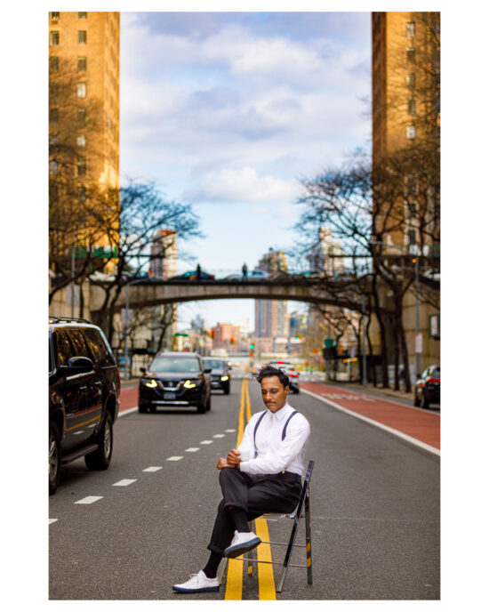 Shaun sitting on a chair in the middle of 42nd Street